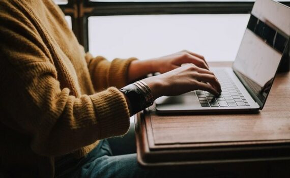 person sitting front of laptop