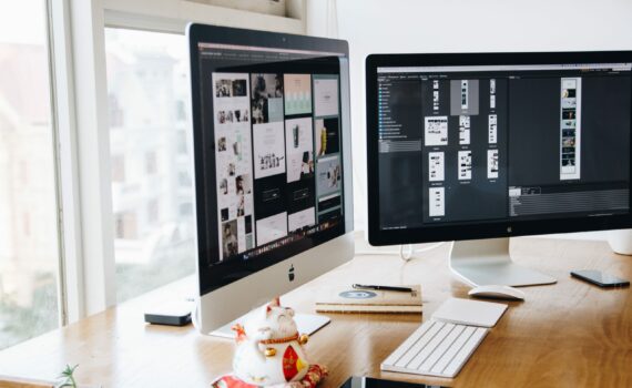 Silver Imac on Top of Brown Wooden Table