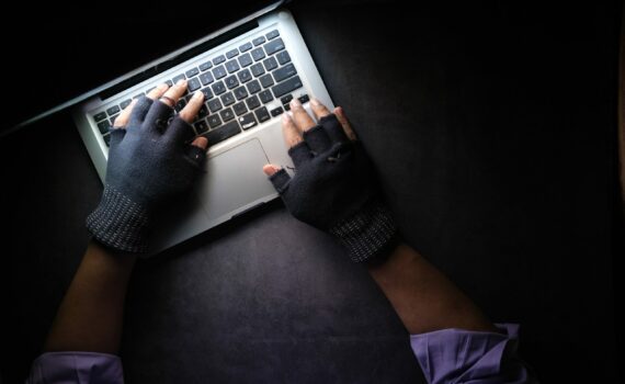 person in black long sleeve shirt using macbook pro