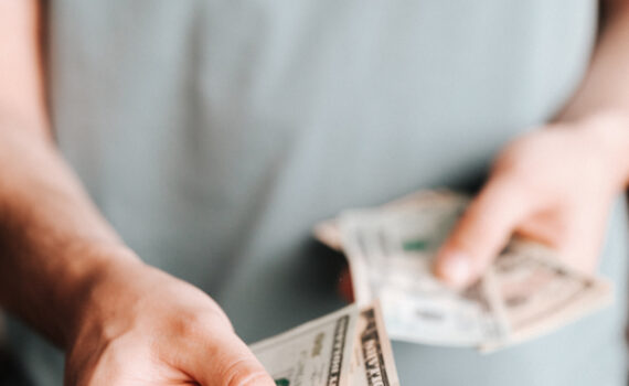 Free Crop man paying with American dollars Stock Photo