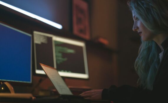 Free Side View of a Woman Using a Laptop Stock Photo