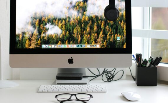 Free Stylish home office workspace featuring a computer setup with accessories. Stock Photo