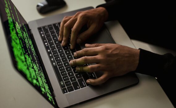 crop-cyber-spy-hacking-system-while-typing-on-laptop
