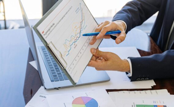 Free Business professionals discussing financial graphs and charts in an office setting. Stock Photo